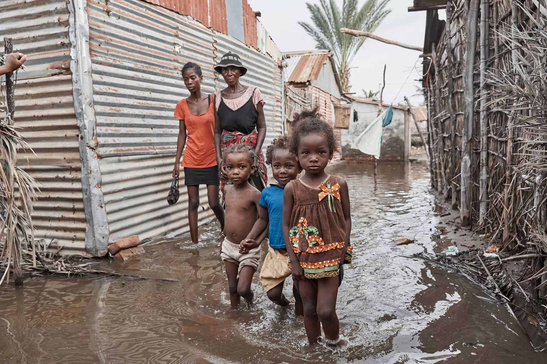 Children walking in the streets of a completely flooded neighborhood in Madagascar