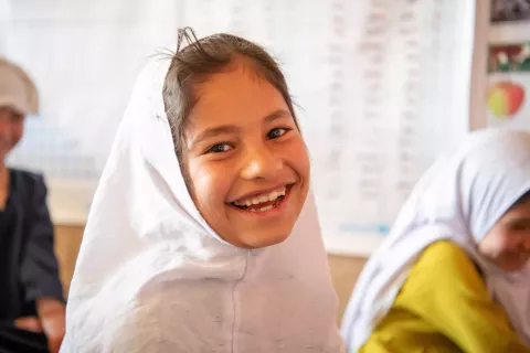 On 22 October 2023, 8-year-old Fatima is happy to learn in her community-based education class supported in Bagh-e-Jalal village, Daikundi province, central Afghanistan.