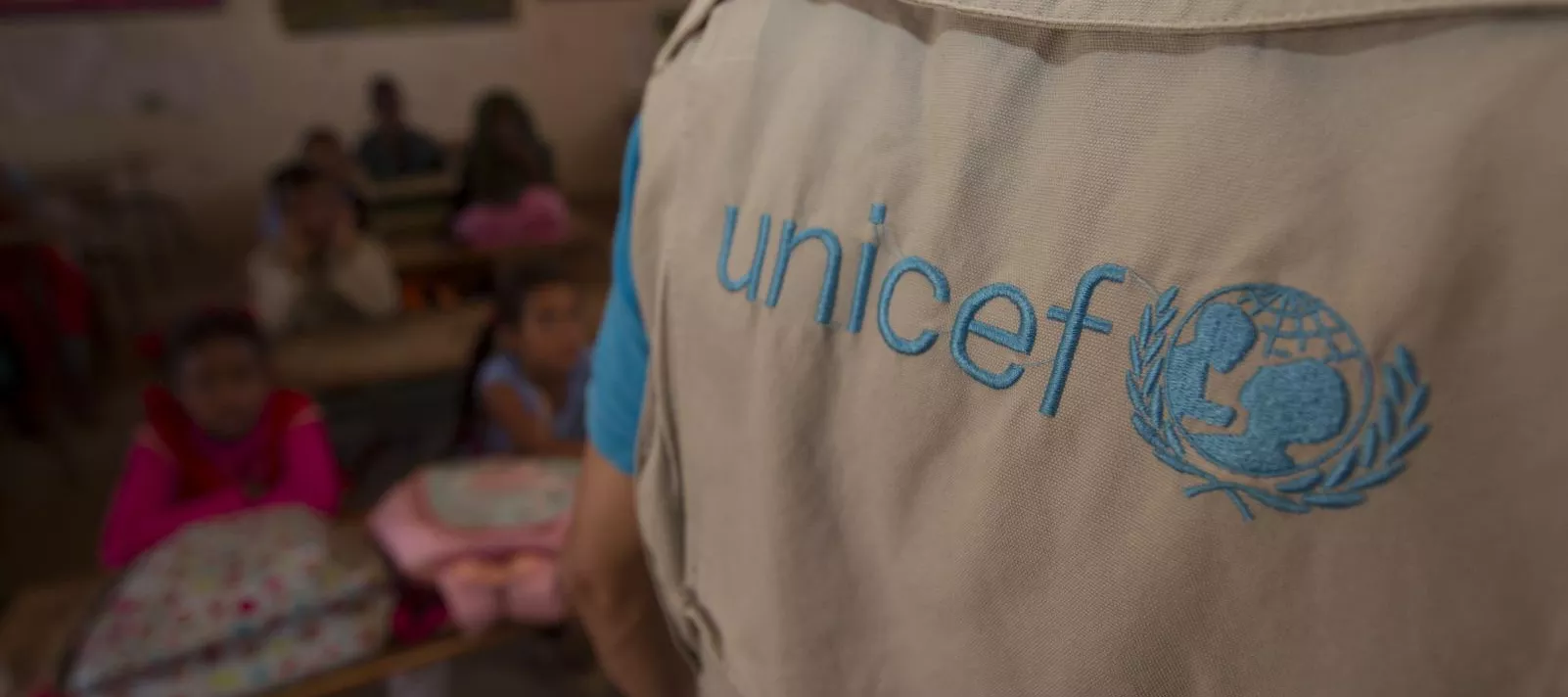 The back of a person wearing a UNICEF branded top