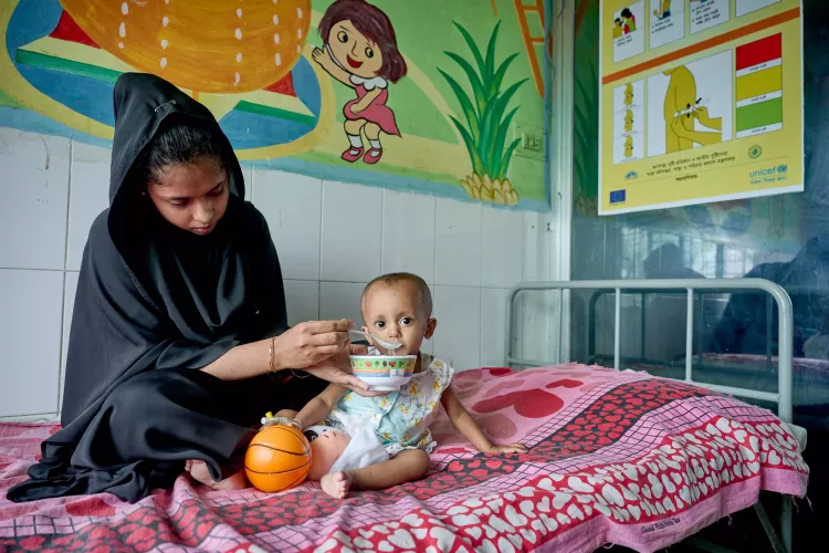 Shabnoor, 22, feeds her 15-month-old daughter Nusaifa therapeutic milk prepared by a nurse at the Severe Acute Malnutrition (SAM) unit in the Teknaf Upazila Health Complex in Cox’s Bazar, Bangladesh.
