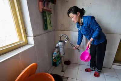 a woman pumping water in her home