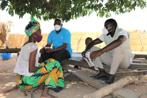 UNICEF staff discuss with a mother of a malnourished child