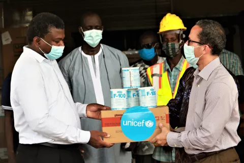 UNICEF The Gambia Representative, Gordon Jonathan Lewis hands over nutrition supplies to the Minister of Health, Dr Ahmadou Lamin Samateh