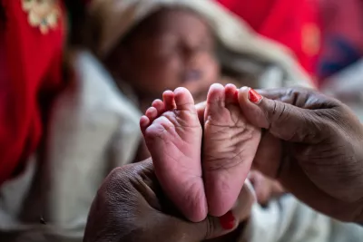 Kiran Devi, an Accredited Social Health Activist (ASHA) examines the newborn child as part of Home Based New Born Care inside a hamlet in Shrawasti, Uttar Pradesh.