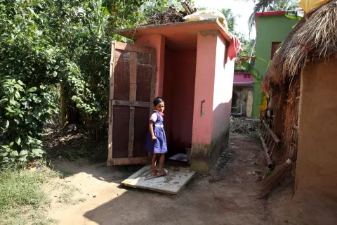 A young girl uses her toilet at home, Raghunathpur, Kujang, Jagatsinghpur, Odisha