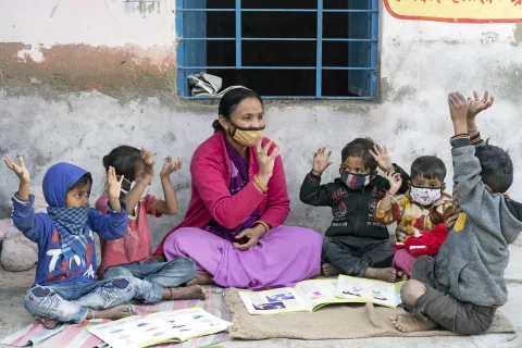 Anganwadi worker Leena Bhat (41 – year – old) playing with the children of the Jethana –A anganwadi Center. 