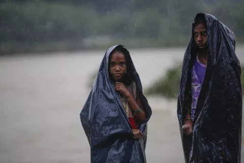 two children sheltering from rains
