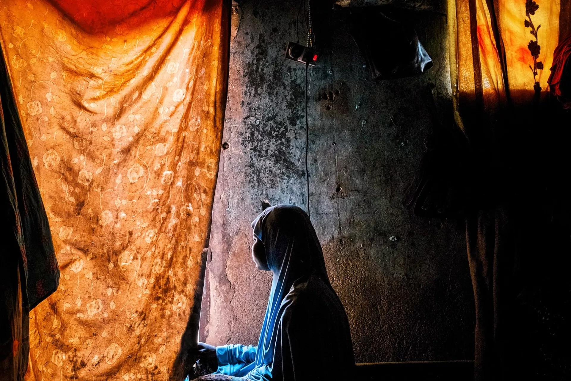 A girl looks out of a window in northeast Nigeria
