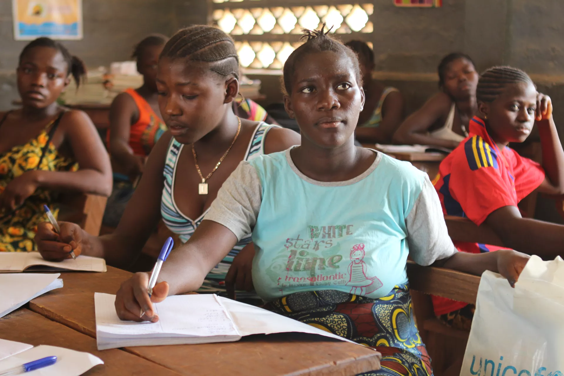A girl sits in a classroom, Sierra Leone