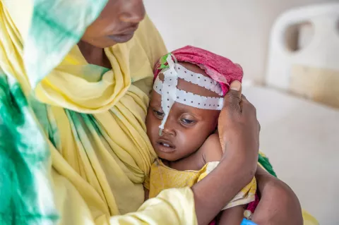 On 27 October 2022 in Puntland, Somalia, 1-year-old Aisha Mohamed is held by her mother, Isniino Ali, while being treated for severe acute malnutrition at Garowe General Hospital Stabilization Centre