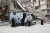 People stand outside a mobile health unit, Syrian Arab Republic