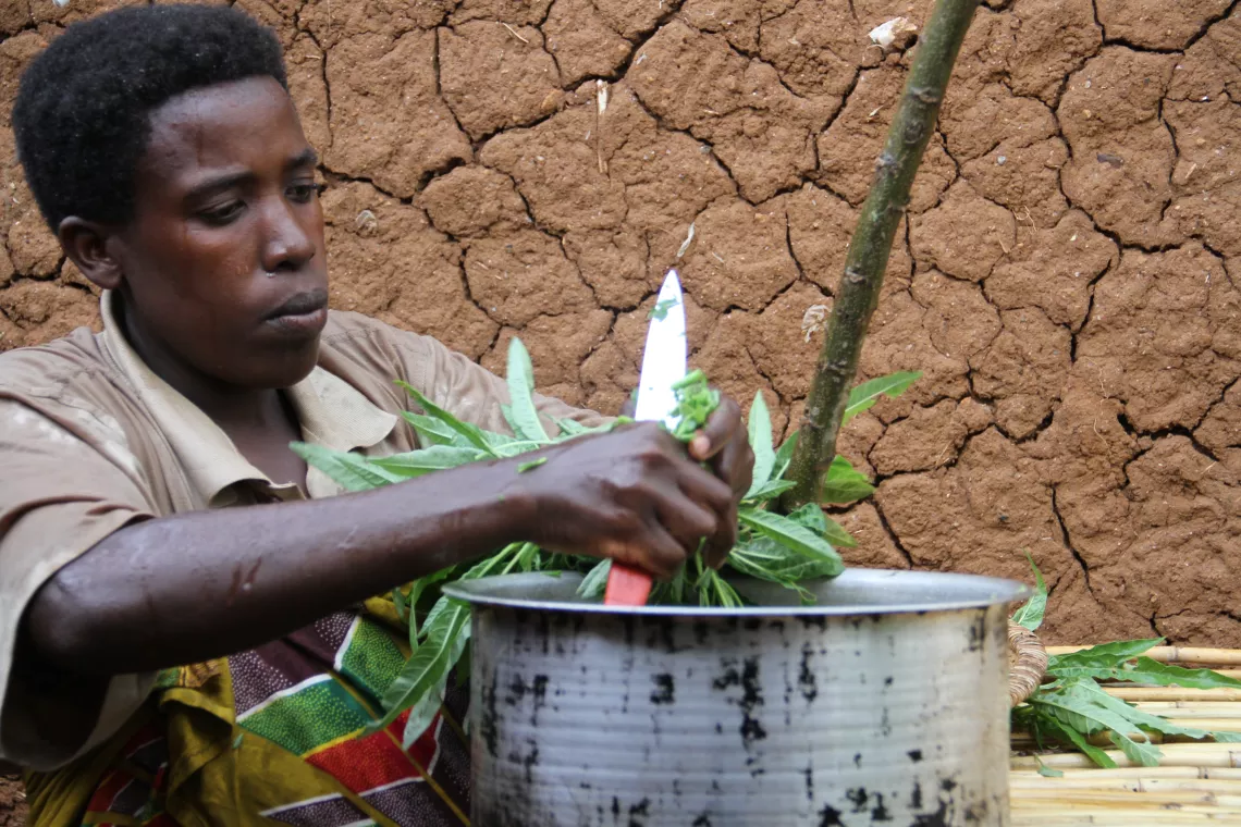 A woman prepares food, Burundi