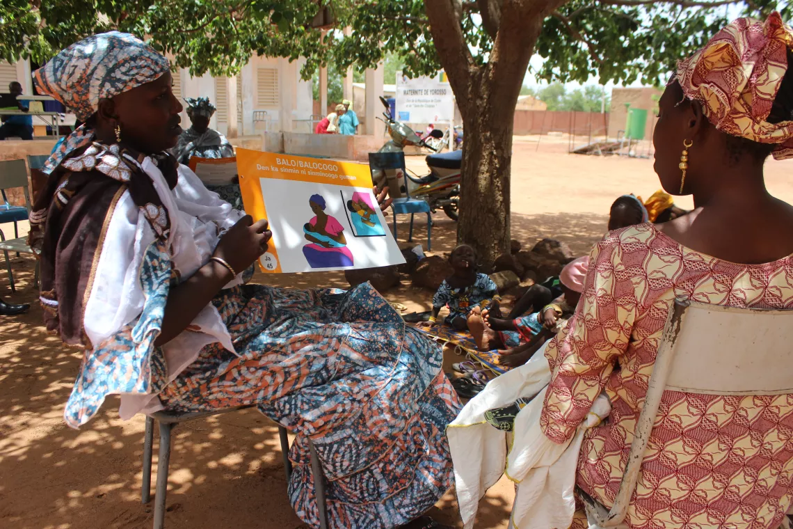 A woman holds up a chart, Mali