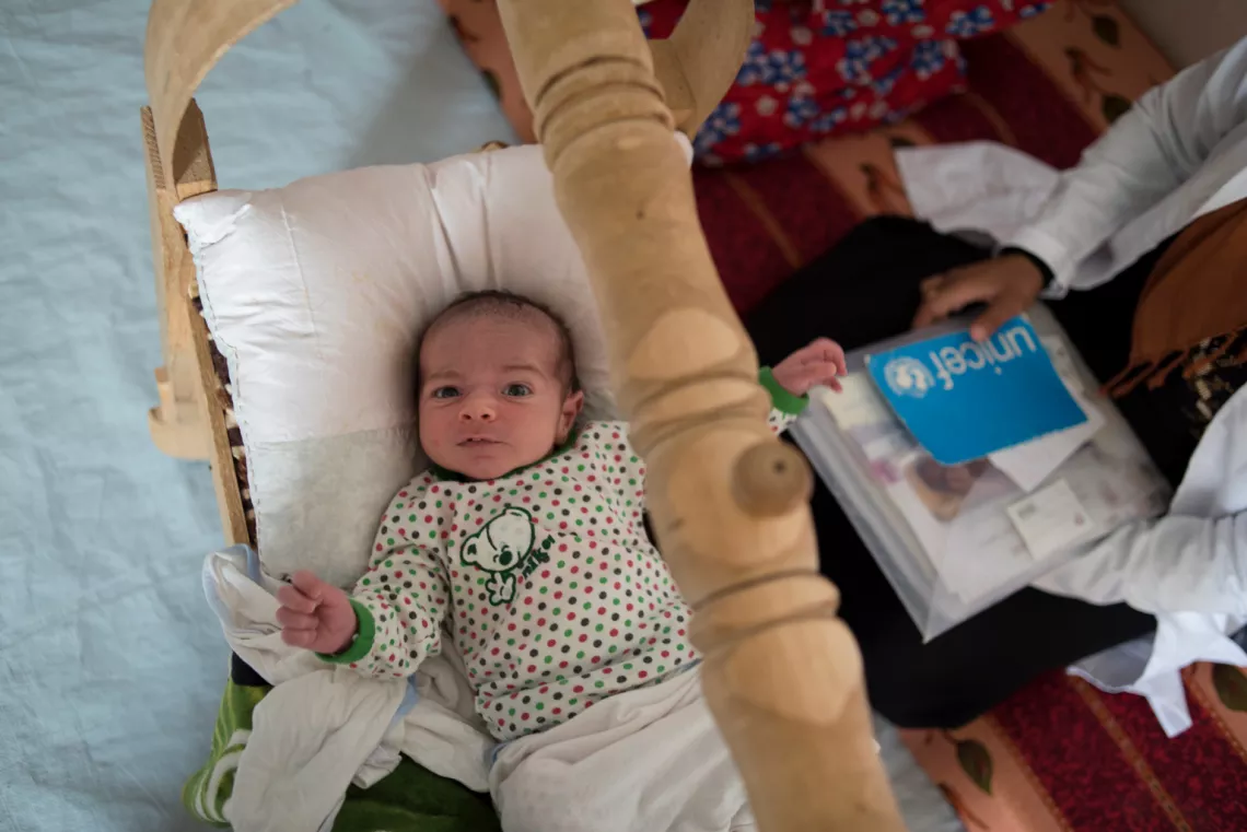 Fourteen-day-old Muhannad lies in his crib.