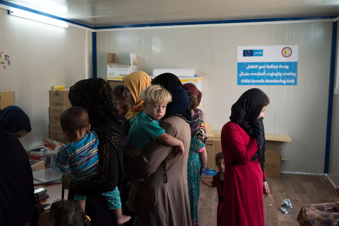 Mothers bring their children to a UNICEF-supported growth and nutrition monitoring unit, or 'baby hut', in Debaga camp.