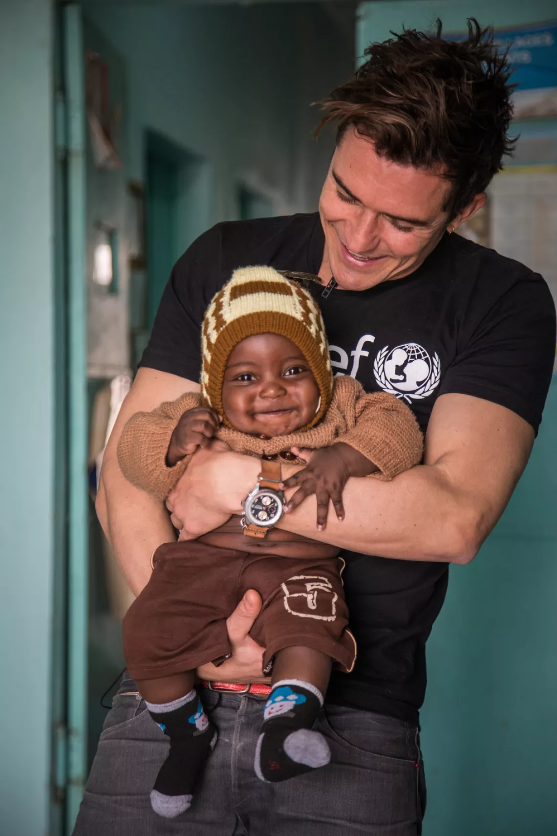 UNICEF Goodwill Ambassador Orlando Bloom holds an infant in Niger.