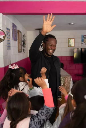 On 23 May 2023 in Tijuana, Mexico, UNICEF Goodwill Ambassador Ishmael Beah greets children while visiting a community centre that serves the needs of internally displaced people.