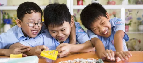 Three boys aged 11 to 14 making beaded necklages at a vocational class for children with disabilities, in the Nguyen Dinh Chieu Special School’s compound in Da Nang Vietnam, in 2012. 