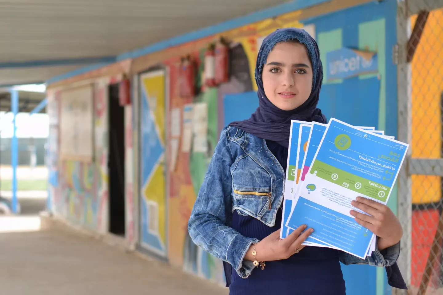 A girl holds up a set of the adapted adolescent kit.