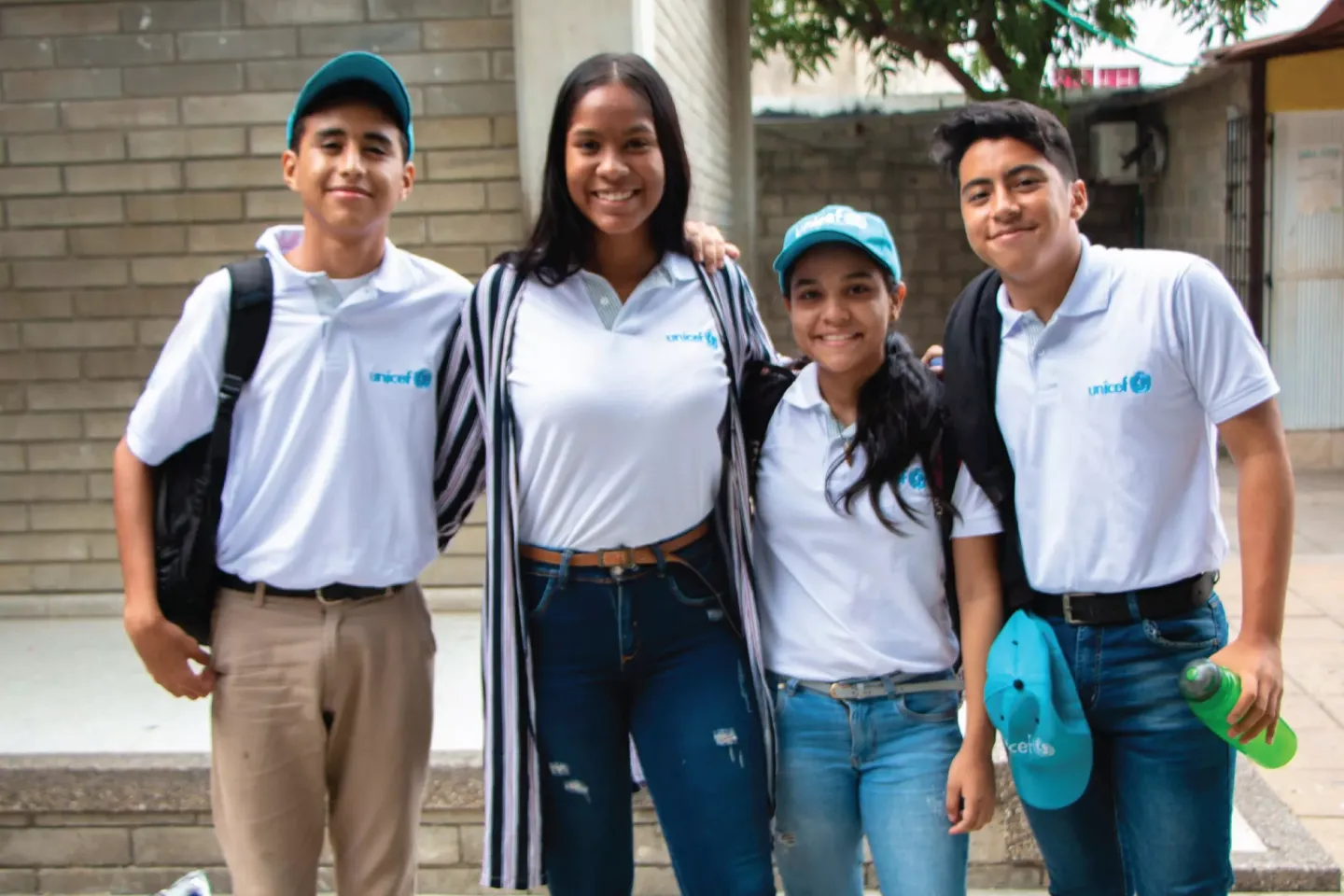Four young people stand together for a photo