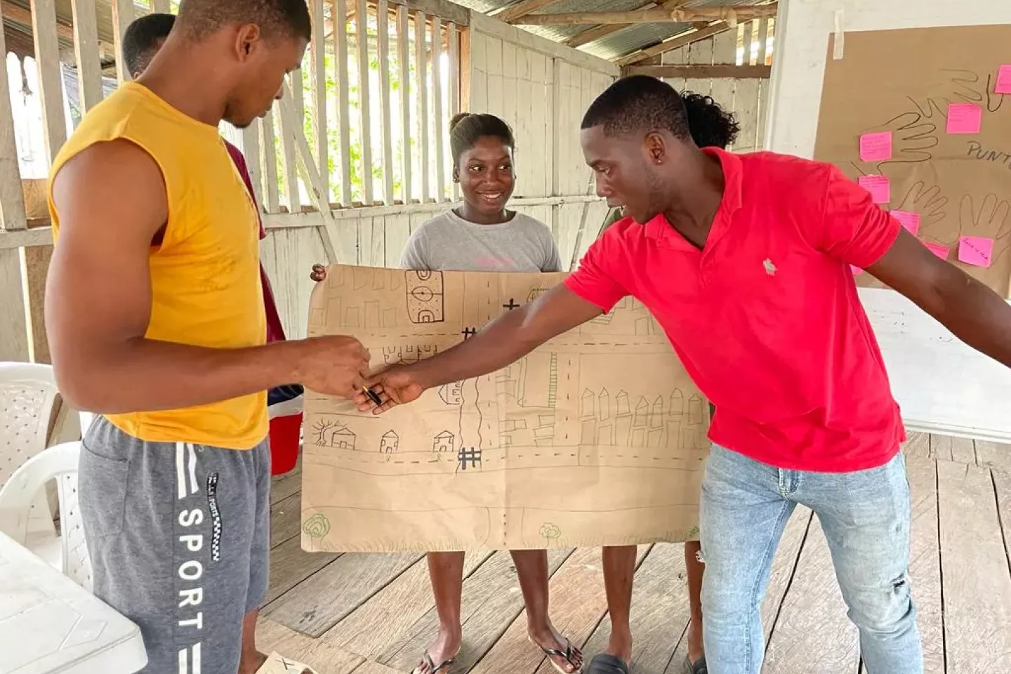 A trainer makes a point on a group made plan