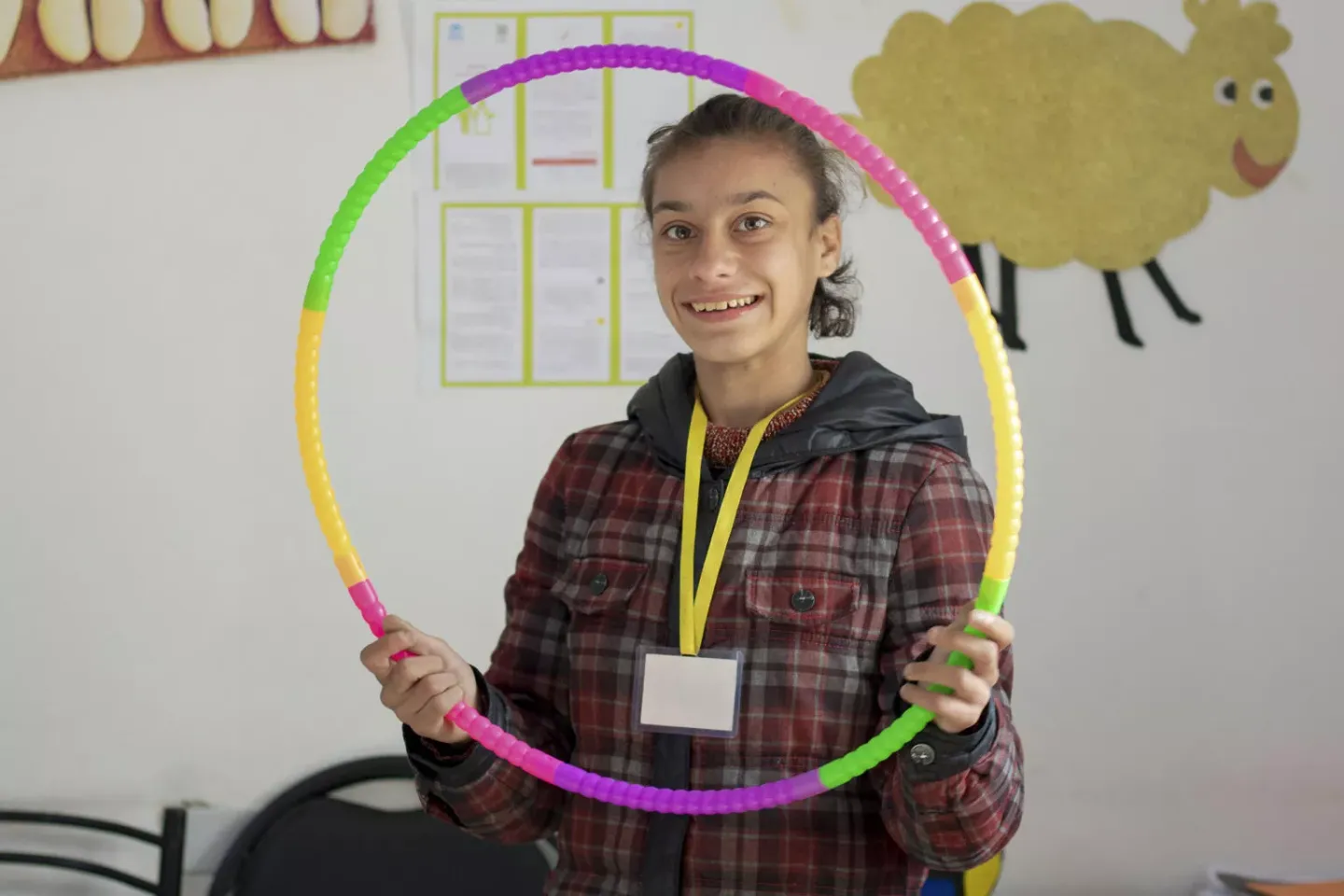 A teenage girl holds a color hoop in a multi-service center in Aleppo. 