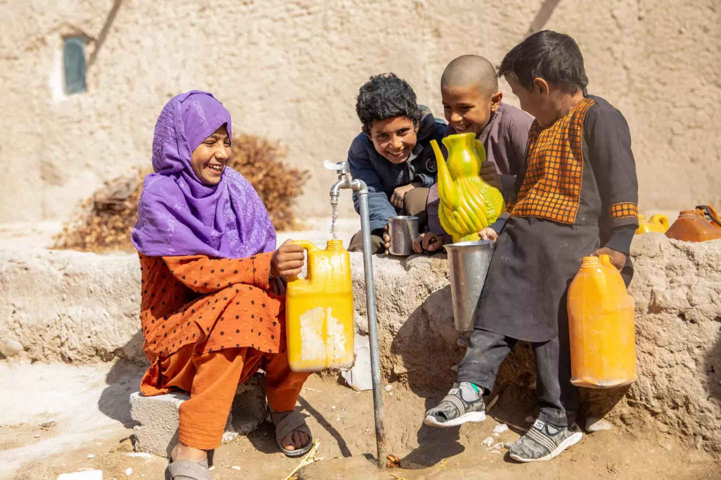 On 10 February 2025, 11-year-old Rozia fills a jerrycan from the water tap at home, part of a new piped water system in Loy Kariz village, Farah province, western Afghanistan.