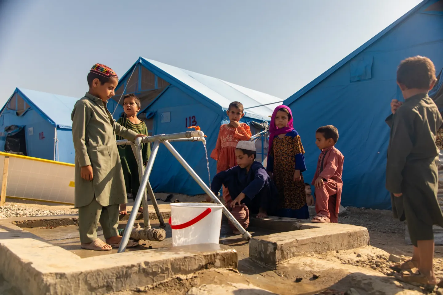 Children fetch water from facilities installed by UNICEF at Khas Kunar Camp for families displaced by the earthquake in Kunar Province, Afghanistan. &copy; UNICEF/UNI875899/Azizi