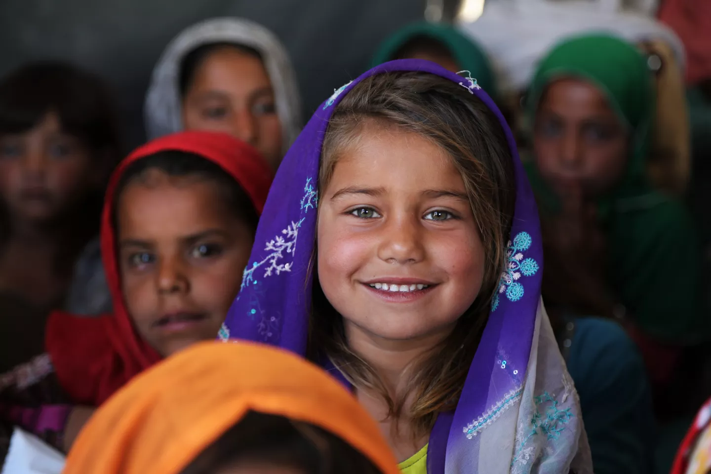 A returnee girl attends a community-based school. 