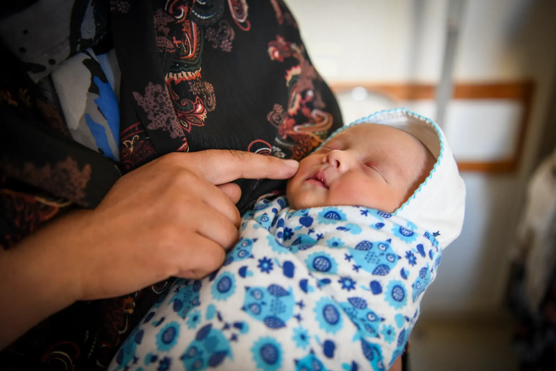 A mother holds her baby at a healthcare facility in Bamyan Province, central Afghanistan.