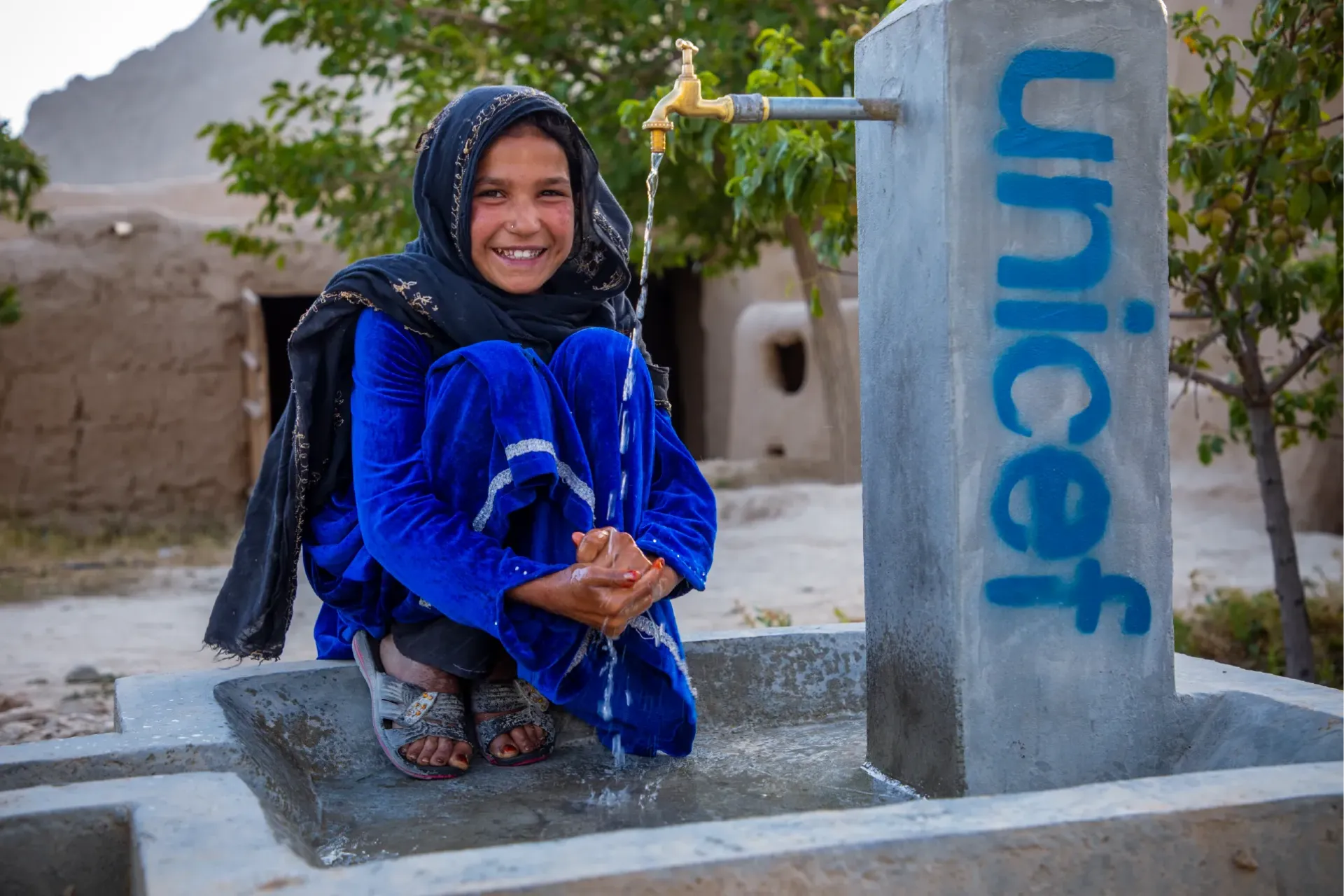 Fauzia, 10 years old girl from Logar province is washing her hands.