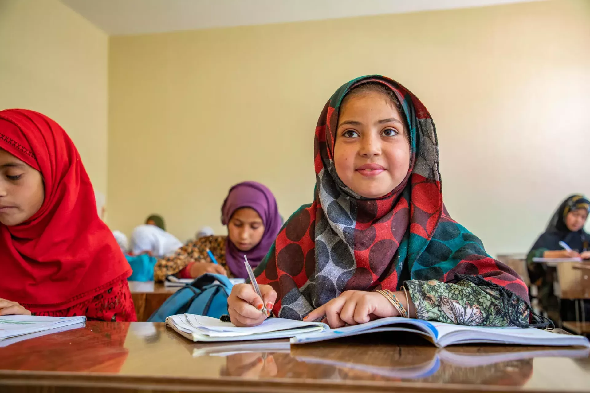 On 28 April, 2025, Amena, 11 years old is studying her lessons in the class at Shaikh Jalal High School in Shaikh Jalal Village, Baghlan province, Afghanistan.