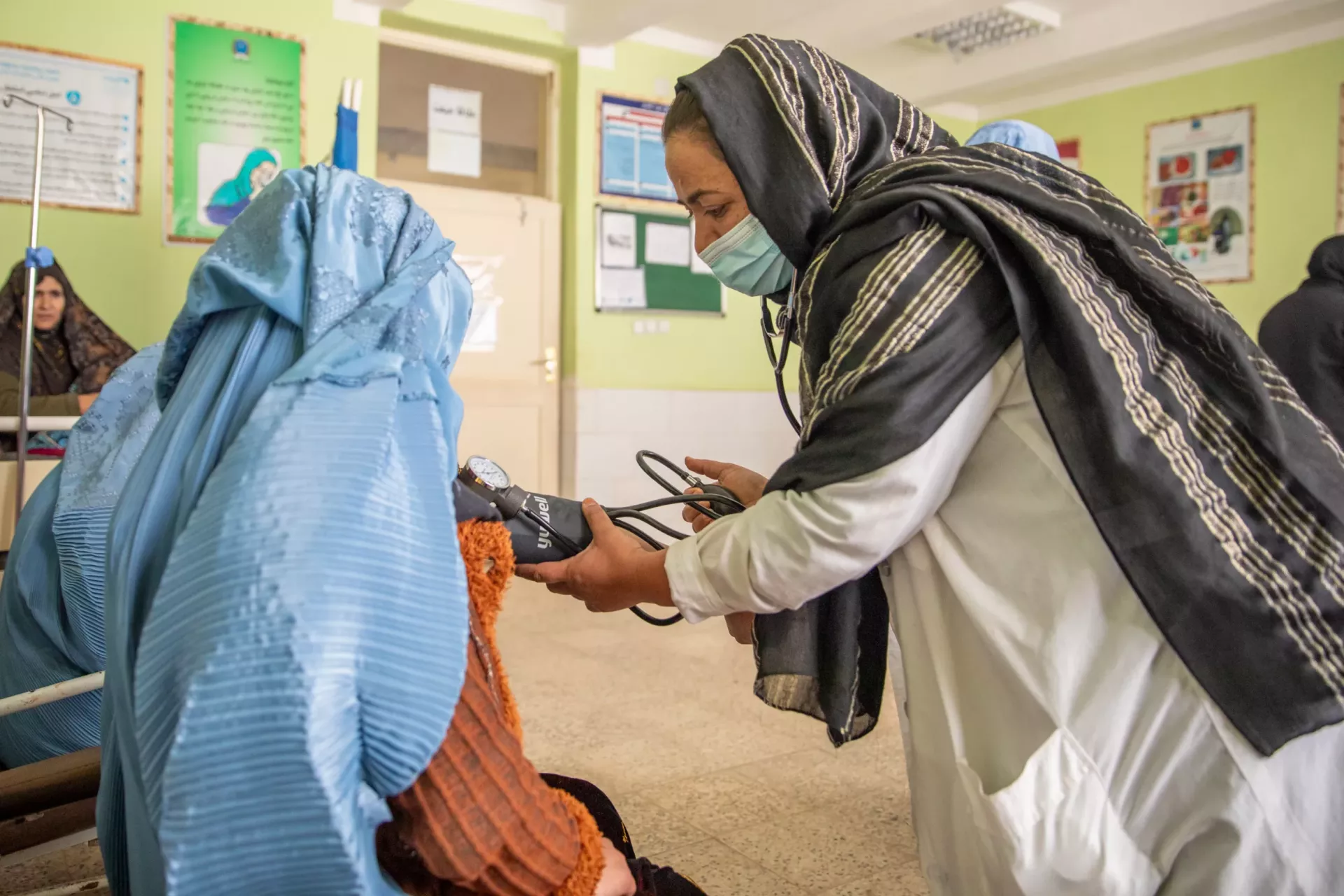 Bibi Gul Sadeqi is checking a pregnant woman (Farida) at Qadis hospital, Haji Qurbanha village, Qadis District, Badghis province.