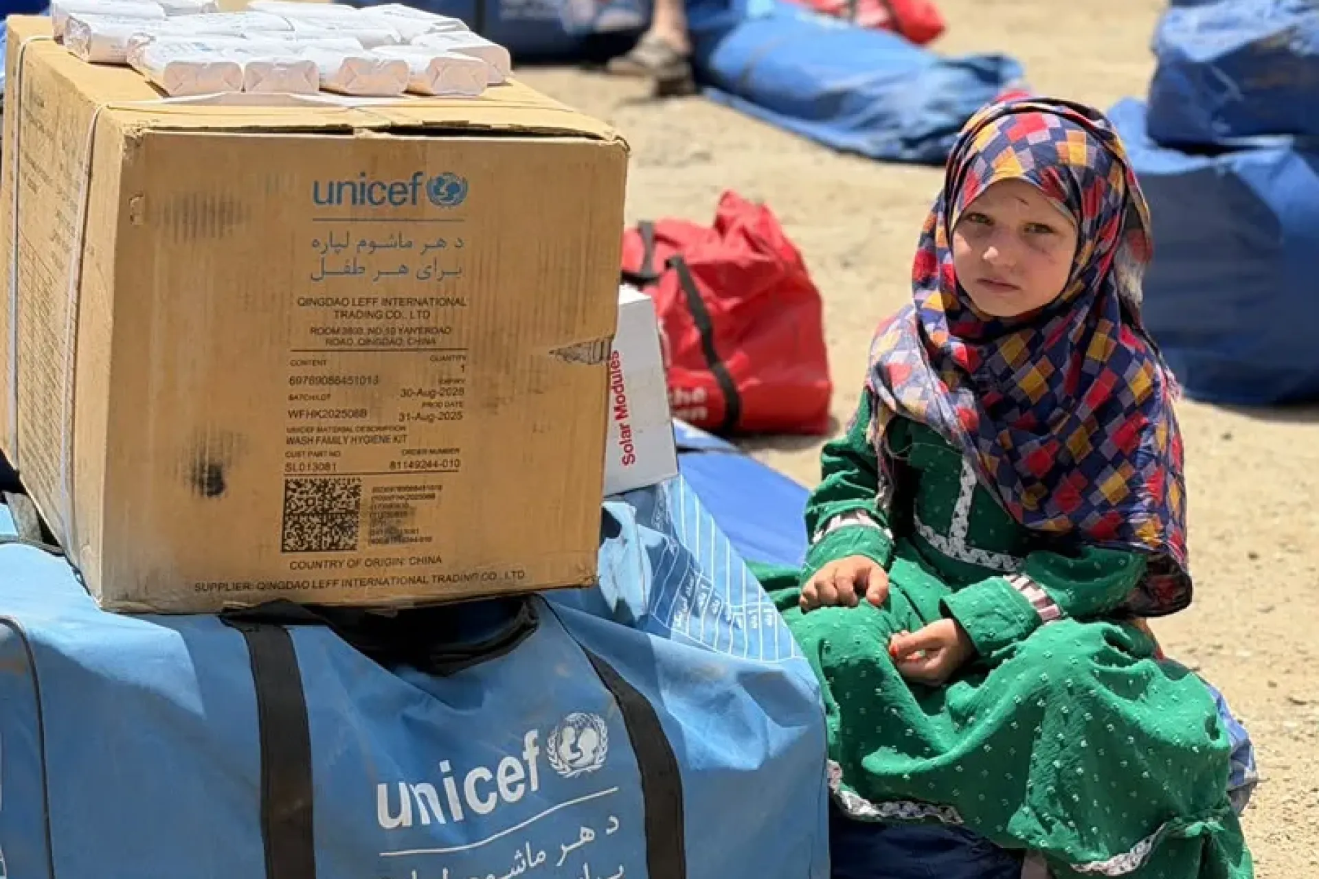 Flash flood affected families including children like her receiving UNICEF kit. 