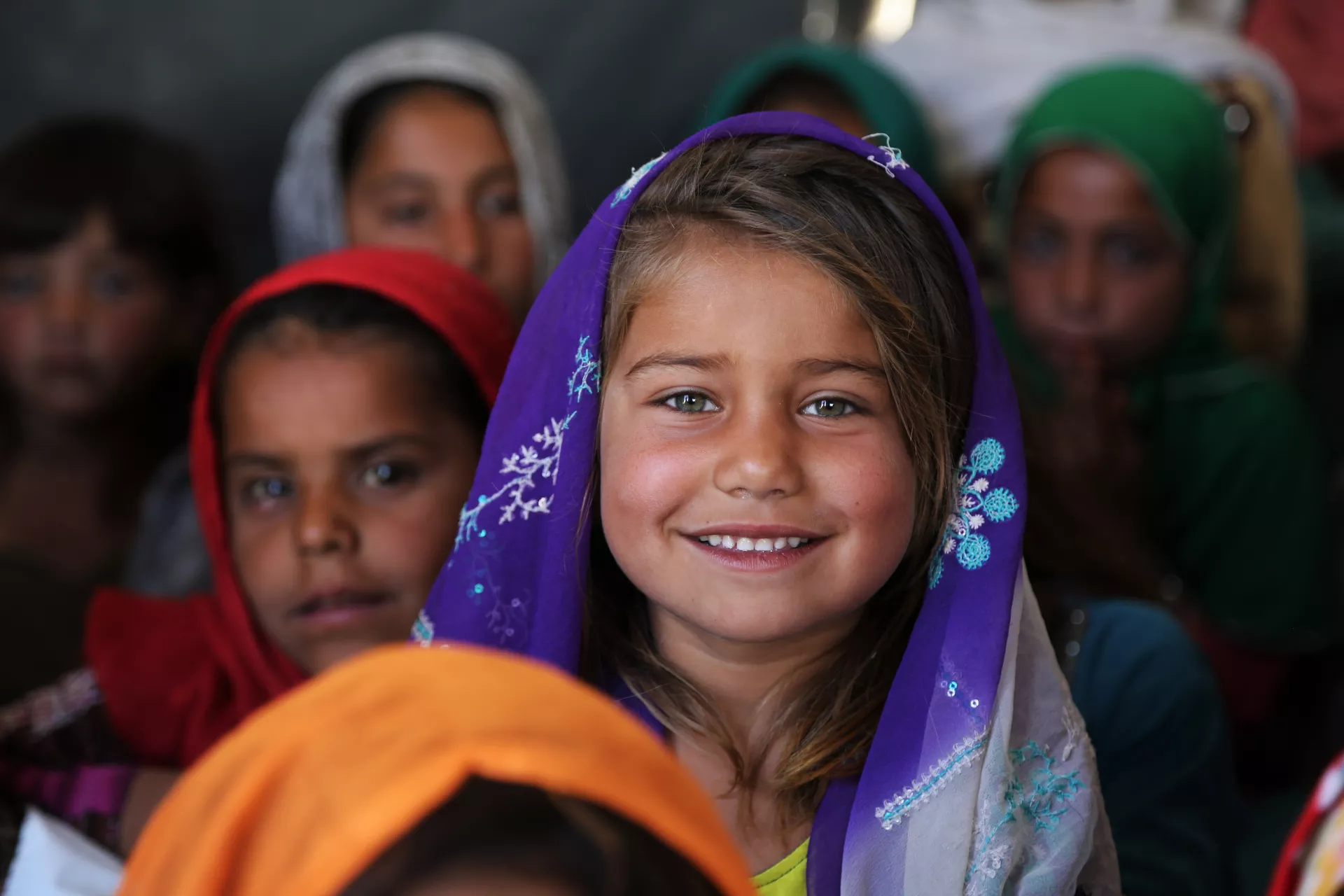 A returnee girl attends a community-based school. 