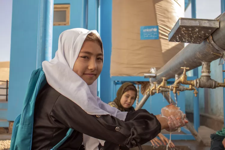 10-year-old Nadia is washing her hands, using the recently built water tap supported by UNICEF at her school.
