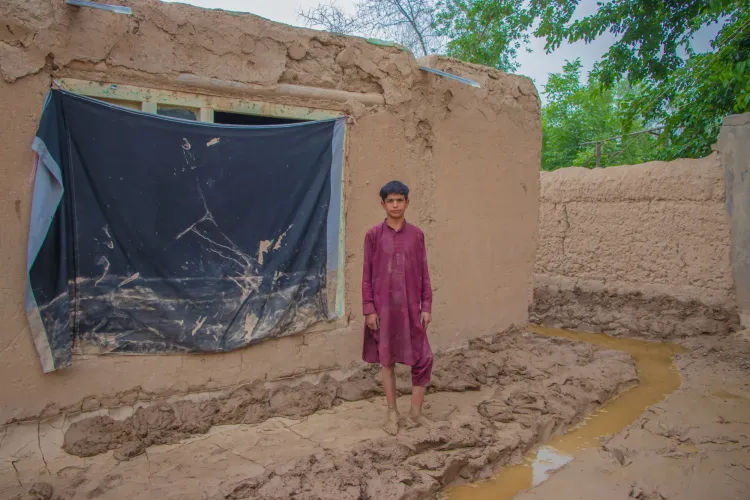  12-year-old Navid is photographed outside his flooded family home in Baghlan province, Afghanistan. His family and himself were affected by the recent flash floods in northern Afghanistan.