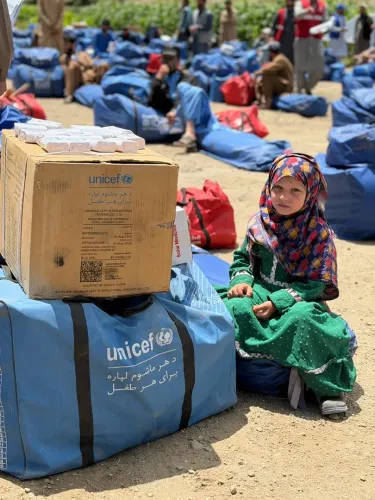 Flash flood affected families including children like her receiving UNICEF kit. 