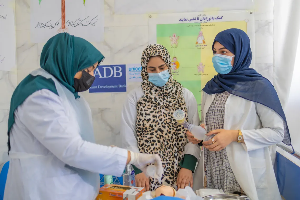 From left, Nabila, 21and Parwana, 25, , practice essential maternal and newborn care techniques under supervision of Suhaila in Guzara District Hospital, Herat, Afghanistan.