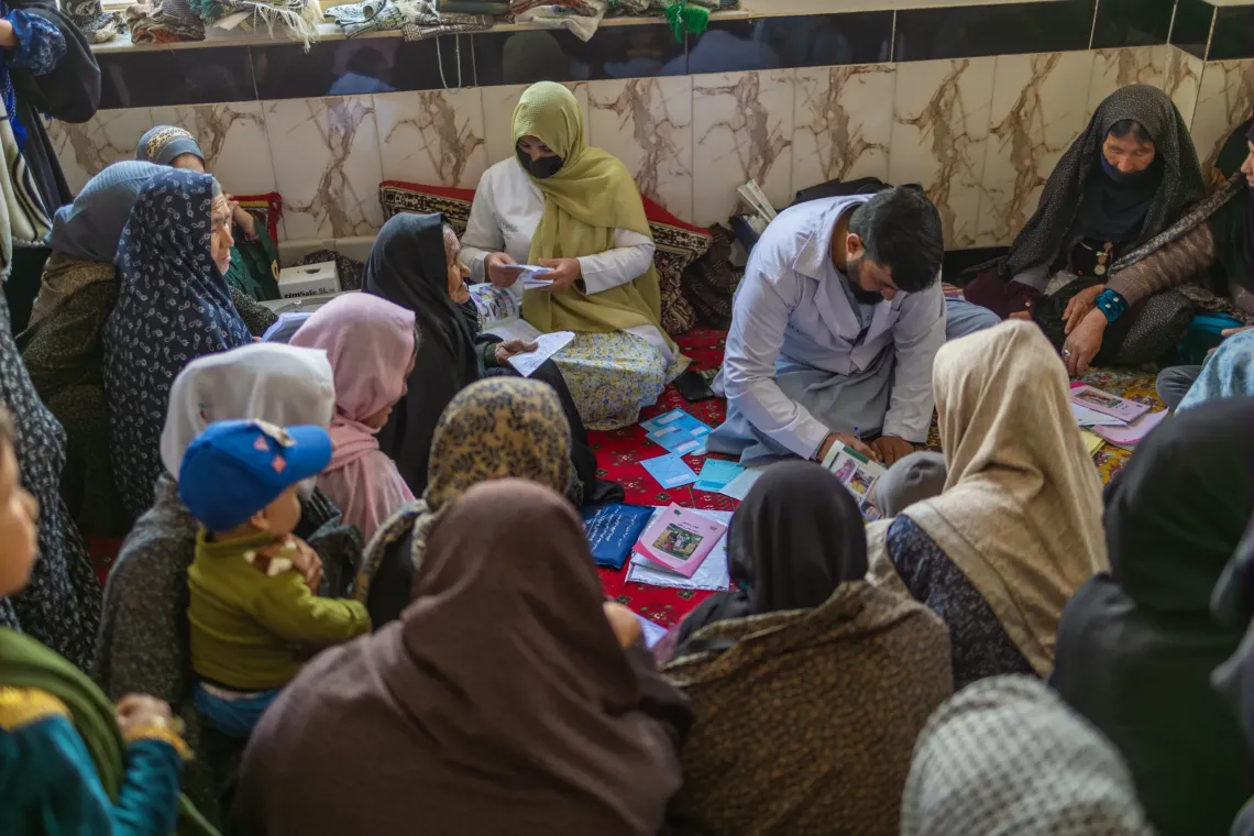 Omid (30) and Nadia (29) check records, register children and women, ensuring that vaccination history is properly documented before administering vaccines. 
