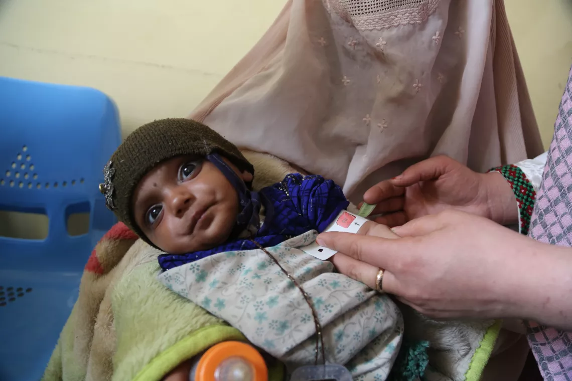 Safa, 7 months old, is suffering from severe acute malnutrition. A nutrition counsellor measures her mid-upper arm circumference to assess if there is any improvement since her last visit to the clinic.