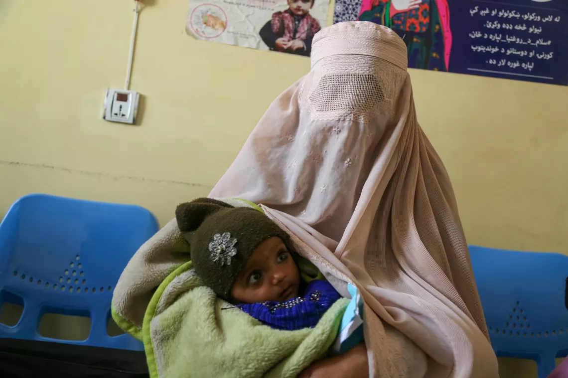 Nooria holds her daughter Safa in the nutrition department at Mirza Mohammad Khan Comprehensive Health Centre in Kandahar, where Safa is being treated for severe acute malnutrition. 