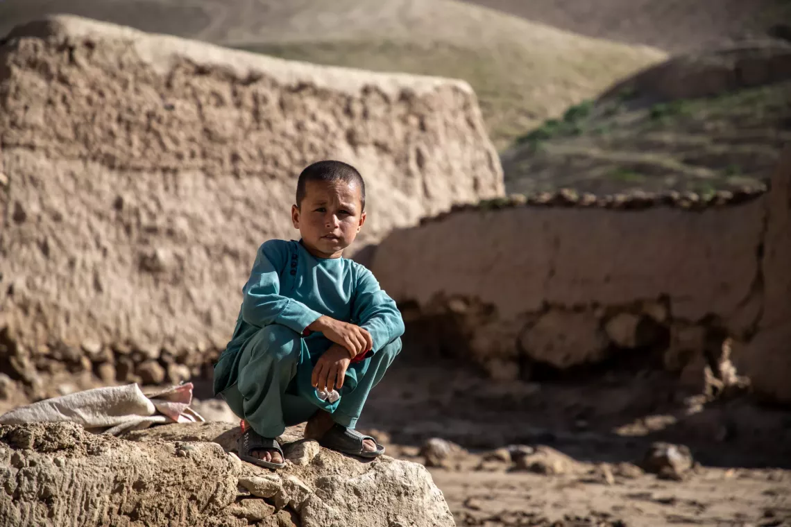 On 14 May 2024, Deen Mohammad, 8, sits where his home used to be in Shaikh Jalal Village, Baghlan-e-Jadid District, Baghlan Province, Afghanistan.
