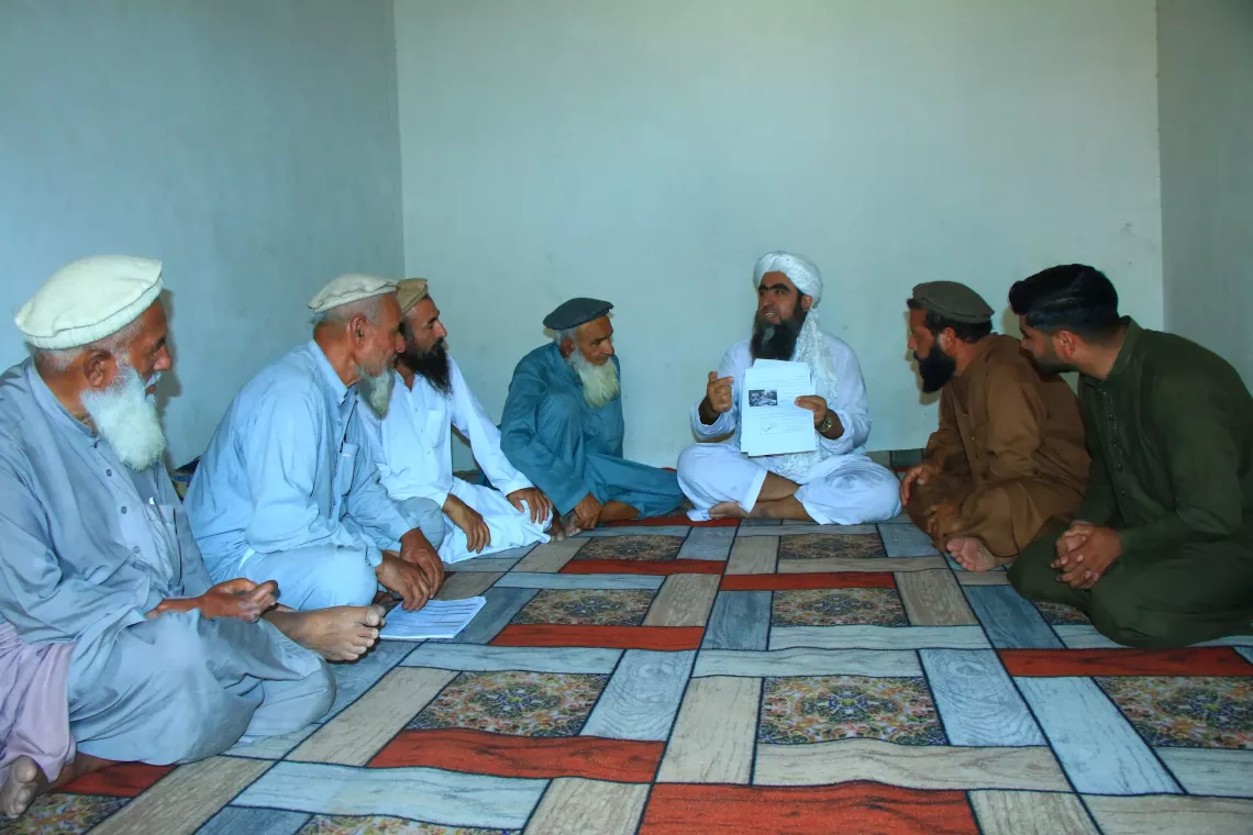 Rabani, a religious leader talks to the community elders about the polio vaccine in Surkhrud district of Nangarhar. 