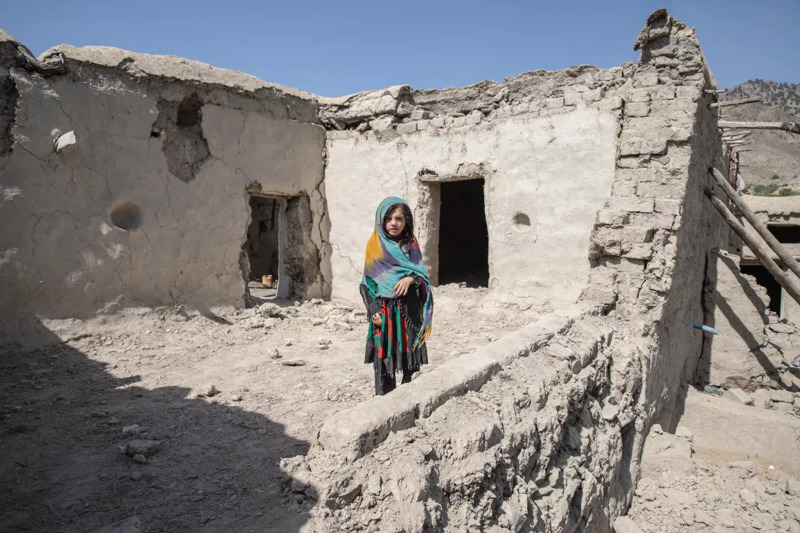 Naghma, 4, stands in the rubble of her home collapsed during the 22 June earthquake in Paktika Province, southeastern Afghanistan.