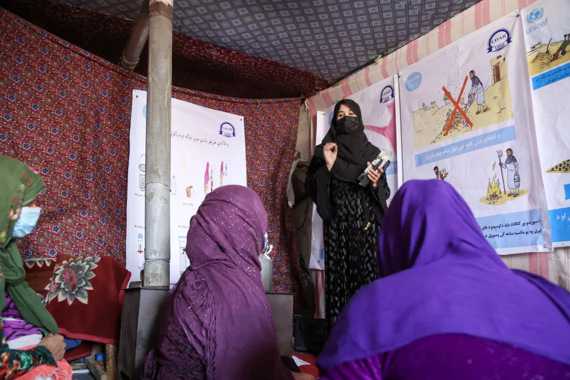 Kamina, far right, attends a hygiene promotion session in Qala-e Abdul Ali informal settlement for internally displaced persons in Kabul, Afghanistan.   During these hygiene sessions, Kamina and other women (there are separate sessions for men) learn about personal hygiene, including menstrual hygiene, and environmental hygiene. 