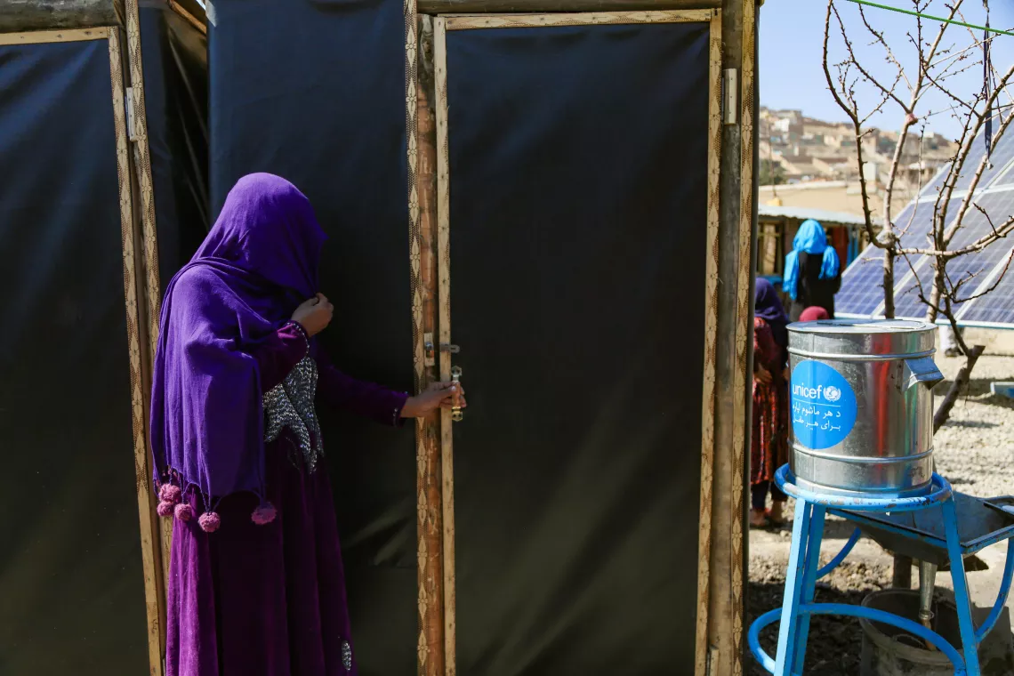 Kamina, her husband and children now have a private and clean toilet just outside their home. Before construction of these toilets, she would defecate in the open and had no place to wash her hands.