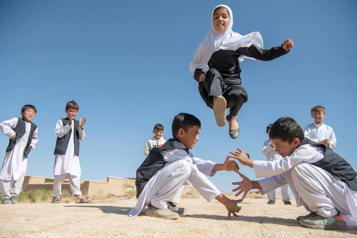 On 22 October 2023, 9-year-old Khadija plays with her classmates at her community-based education class supported in Bagh-e-Jalal village, Daikundi province, central Afghanistan.