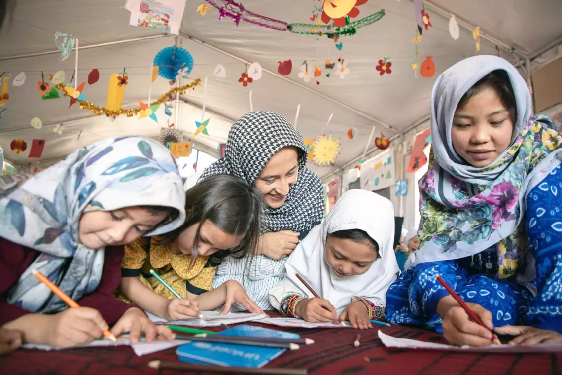On 22 August 2023, a group of girls draw inside the UNICEF-supported Child-Friendly Space (CFS) in Korae Mili, Herat province, Afghanistan.