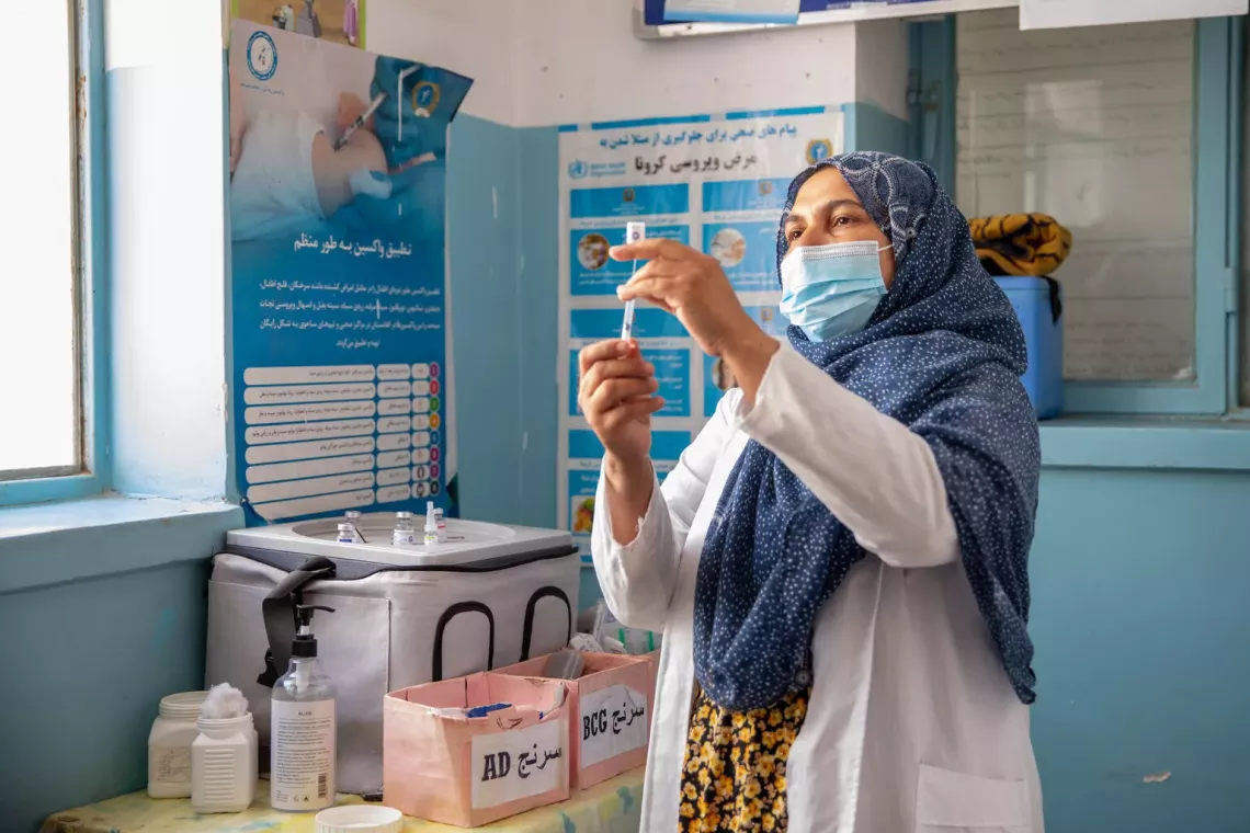 On 14th of April 2025, Karima Azimi is preparing vaccine. she has been working as fixed vaccinator at Rawashan health facility in Injil district of western Herat province. On average, she is vaccinating 50-55 children on daily basis.